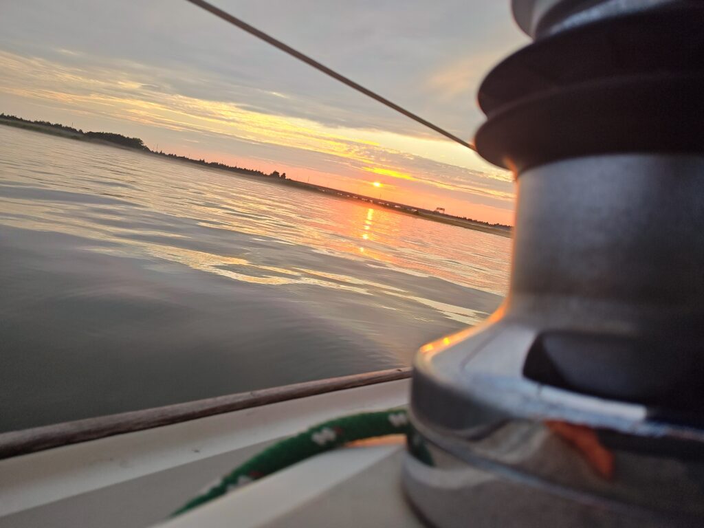Golden sunset over the water during an Ocean City NJ sailing charter